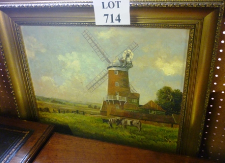 A framed and glazed oil on canvas country landscape farm scene with windmill and cattle in