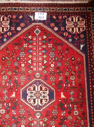 A 20c Persian rug on blue ground and stylised animals est: £80-£120