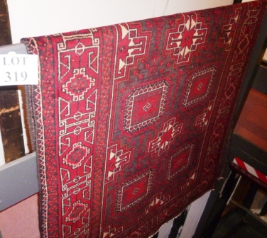 A Balouchi rug in good condition (230 cm x 120 cm approx) est: £70-£100