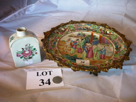 A Canton Famille Rose plate in gilt metal 'tazza' mount; and a Chinese tea caddy with flower