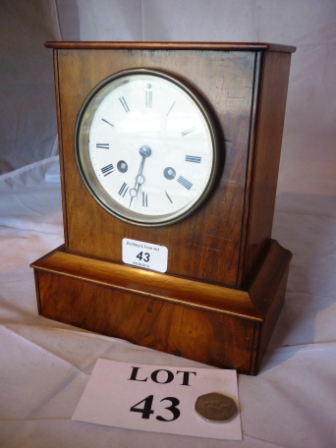 A late 19th century walnut cased mantle clock with French movement (pendulum and key with