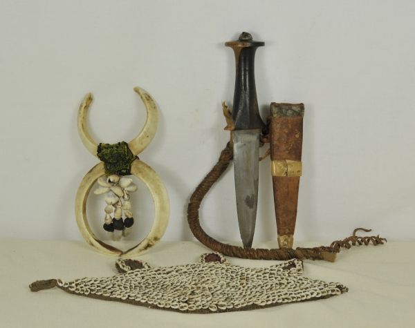 Ethnologica  Tschad, warriors decoration.  1.) Arm dagger: Iron blade, wodden grip, leather scabbard