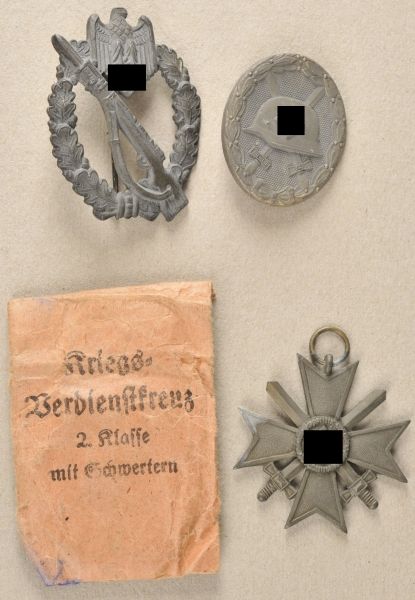 Germany (1933-1945)  Estade with 3 badges.  1.) War Merit Cross, 2. class with swords, in bag; 2.)