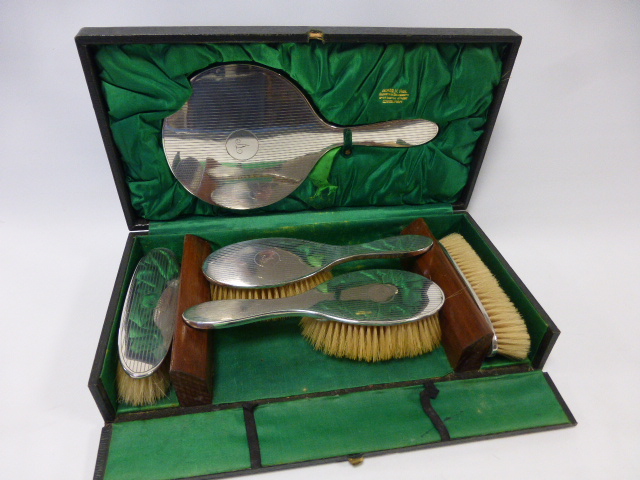 Silver five piece dressing table hand mirror and brush set, with engine turned decoration and