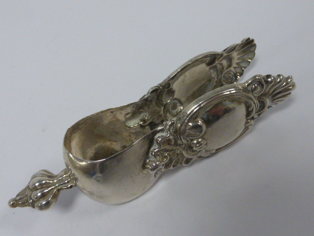 French silver lemon tongs with embossed decoration, stamped with Minerva head, 10.5cms in length