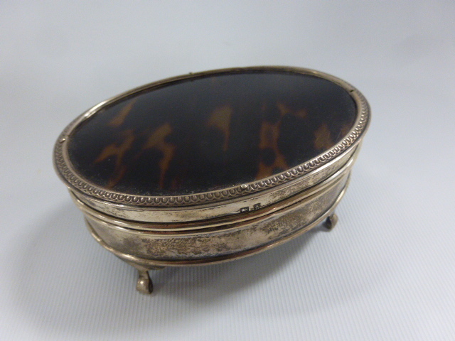 A George V oval silver and tortoiseshell lidded dressing table pot, hallmarked Birmingham 1925, by