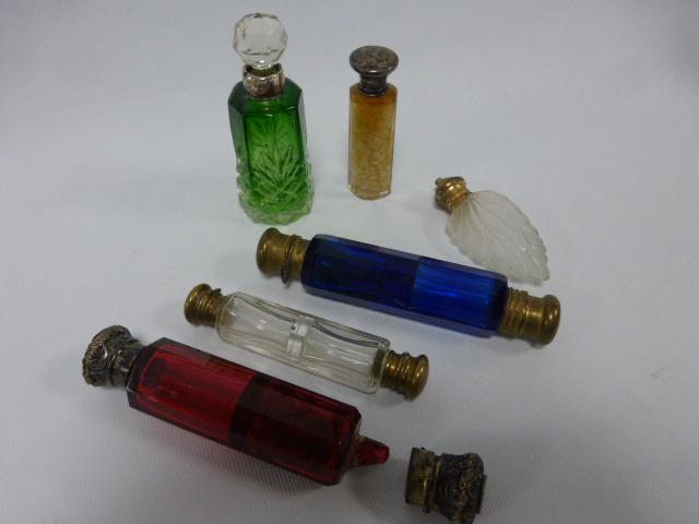 A collection of six Victorian and later scent bottles to include a green cut glass bottle with