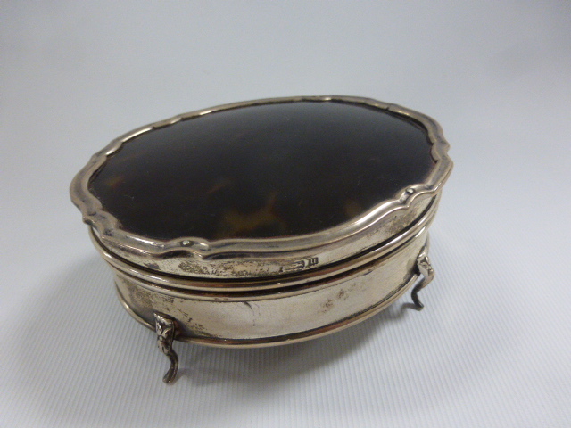 A George V oval silver and tortoiseshell lidded dressing table pot, hallmarked Birmingham 1919, by