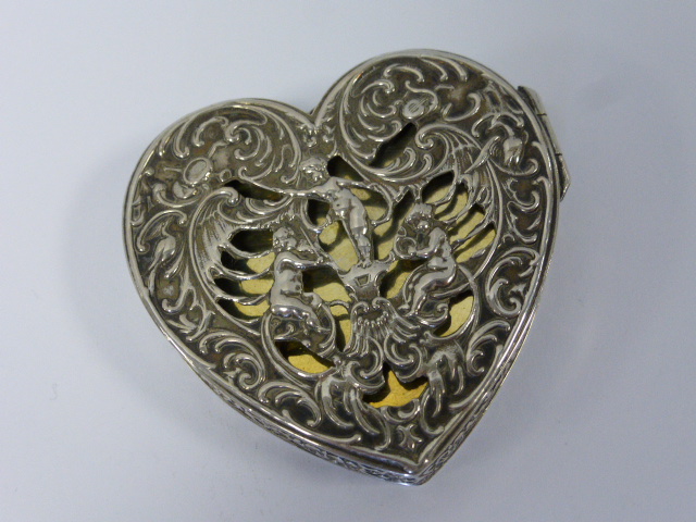 Hanau silver heart shaped trinket box with pierced decoration of embossed cherubs playing musical