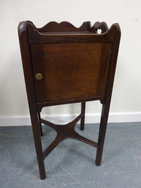 A 19th Century pot cupboard, with shaped gallery rail and pierced carrying handles over single door,