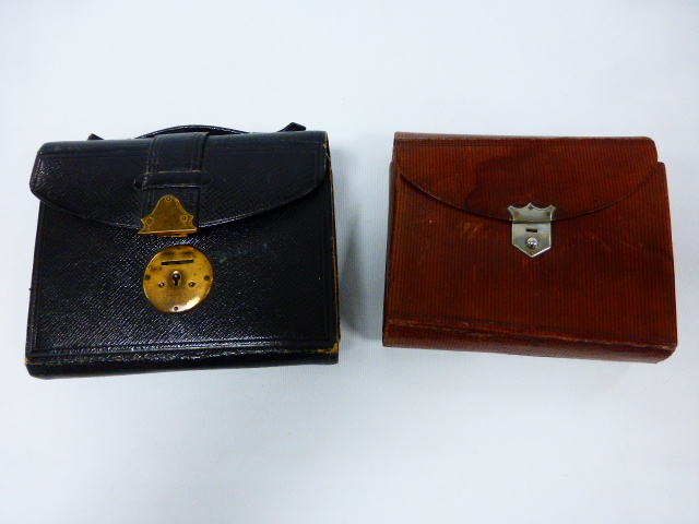 Two early 20th Century leather cases, both stamped The ``Epitome`` Tourist, one with black leather