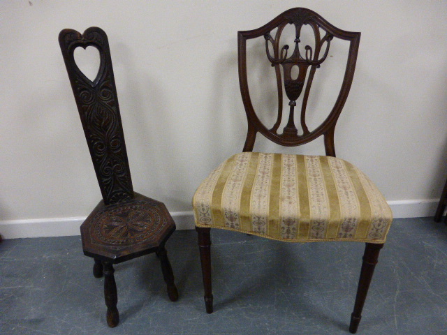 A 19th Century shield back chair with carved twin handled urn and sheaf of corn decoration, with