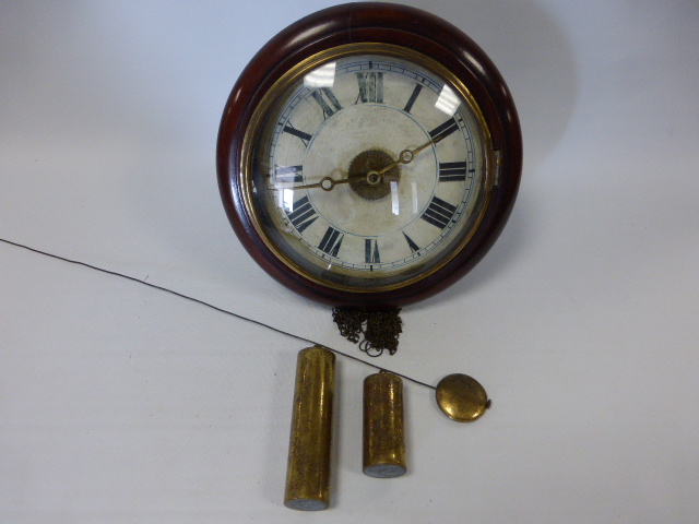 A 19th Century mahogany circular framed Postman`s wall clock with pendulum and weights