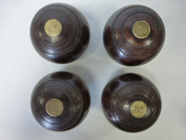Set of four lawn green bowls by William Sykes of Horbury
