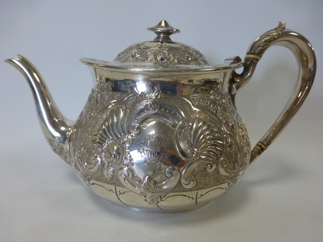 Victorian silver teapot embossed with scrolls, floral and foliate decoration, hallmarked Sheffield