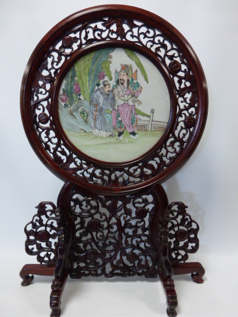 Chinese Table Screen with circular porcelain plaque depicting a pair of figures in a walled garden,