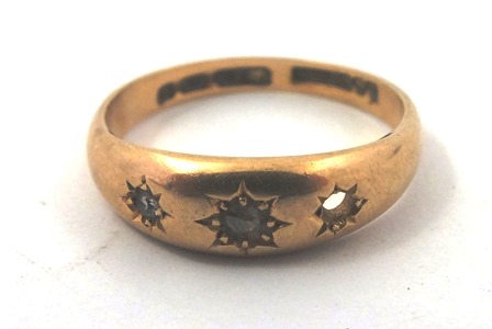 A GYPSY GOLD COLOURED METAL DRESS RING, for three stones, old cushion cuts, in a beaded setting,