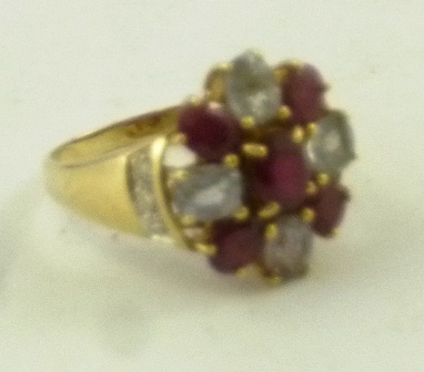 A 9ct GOLD DRESS RING having an oval head set with a star of five rubies interset with four pale - Image 2 of 2