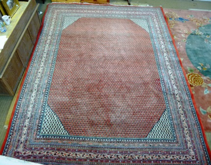 A HAMADAN PERSIAN CARPET, having madder and ivory centre with multiple desert flowers within a