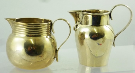 F** E** A GEORGE III SILVER CREAM JUG having rolled rim and baluster body with reeded handle,