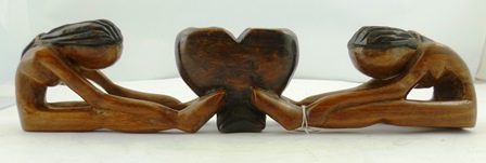 AN AFRICAN CARVING of two nude native women supporting a vessel with their feet, 10cm x 44cm wide - Image 3 of 4