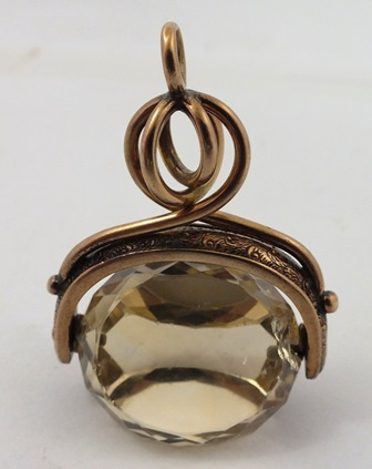 A GOLD COLOURED METAL SEAL fashioned as a triple facetted citrine with entwined wire head - Image 2 of 2