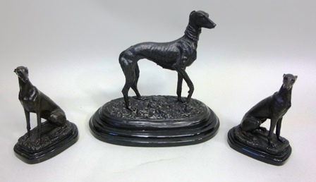 A SUITE OF THREE CAST AND PATINATED 20TH CENTURY MODELS OF GREYHOUNDS, a pair seated and one