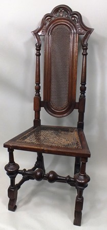 AN EARLY 20TH CENTURY CAROLEAN STYLE CHAIR having shaped crest rail, turned uprights, cane centre,