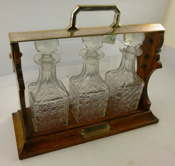 AN OAK AND EPNS MOUNTED TANTALUS having three lead crystal decanters and stoppers and an un- - Image 3 of 3