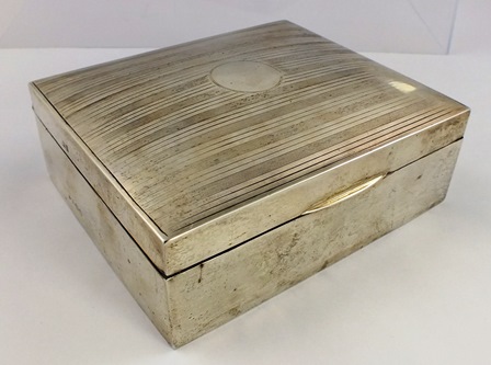 ** & CO AN OBLONG SILVER CIGARETTE BOX having engine turned domed hinged lid unengraved with timber