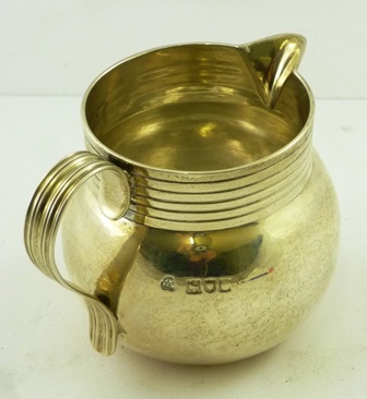 F** E** A GEORGE III SILVER CREAM JUG having rolled rim and baluster body with reeded handle, - Image 3 of 6