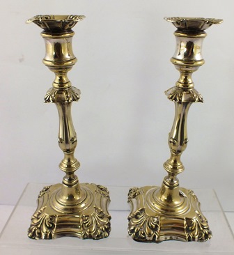 ELKINGTON & CO. A PAIR OF GEORGIAN STYLE LOADED CANDLESTICKS, each having anthemion decorated