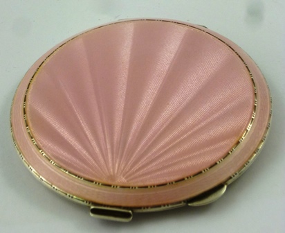 HENRY CLIFFORD DAVIES A CIRCULAR SILVER POWDER COMPACT, having engine turned and pink enamelled top