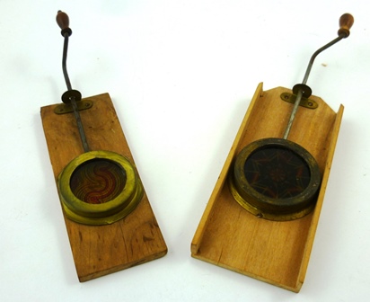 TWO 19TH CENTURY MECHANICAL KALEIDOSCOPE SLIDES, wood mounted with turning rod handles