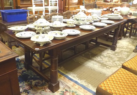 A 20TH CENTURY RUSTIC STYLE OAK REFECTORY TABLE, having plank top, on four turned and blocked legs