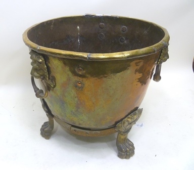 A PROBABLY 20TH CENTURY CIRCULAR BRASS LOG BIN,  with rolled rim & seamed, having twin flank lion