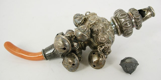 A LATE VICTORIAN/EDWARDIAN CHILD`S SILVER TEETHING RATTLE having eight bells and pressed