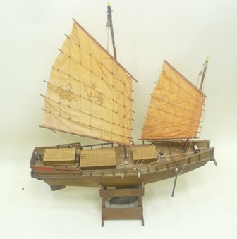 A SCRATCH BUILT PLY POND YACHT ""JUNK"" with painted sails, string rigging, two figures, and leaded