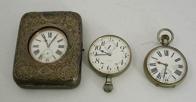 A SILVER FRONTED DRESSING TABLE POCKET WATCH HOLDER, the front pressed with angelic heads,