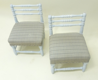 A PAIR OF LATE VICTORIAN FOOTSTOOLS probably beech framed, with triple turned low ladder backs,