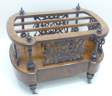 A VICTORIAN WALNUT CANTERBURY having fancy lobed top with four finials fitted uprights, on a base