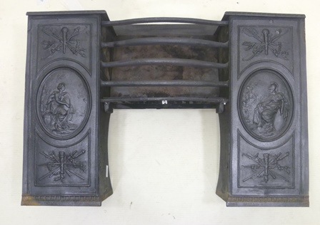 A VICTORIAN STYLE CAST IRON FIRE GRATE having the remains of a central rack flanked by ornamented