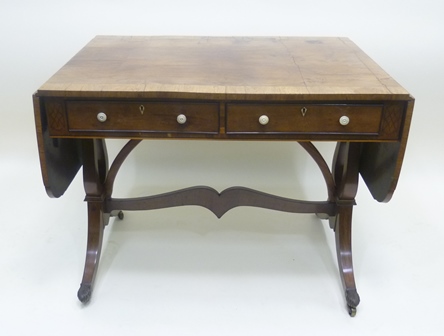A REGENCY/EARLY 19TH CENTURY MAHOGANY SOFA TABLE having crossbanded twin flap drop top over twin