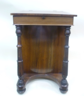 A VICTORIAN ROSEWOOD DAVENPORT having lift up top with rexine skiver, four flank drawers with