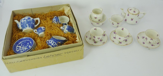 AN EARLY 20TH CENTURY GERMAN PORCELAIN MINIATURE TEA SET decorated in violets and gilt, comprising