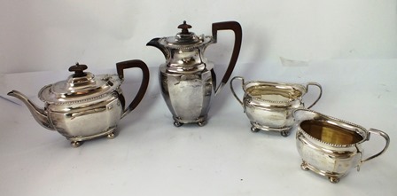 ATKIN BROTHERS A SILVER FOUR PIECE TEASET each having gadroon & scroll rim decoration, raised on 4