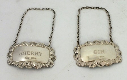 HAMPTON UTILITIES & ANOTHER TWO SILVER DECANTER LABELS, each having a pressed foliate and shell