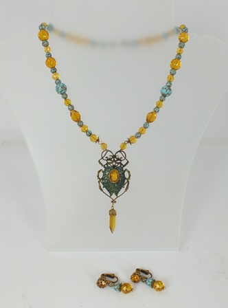 A PLIQUE A JOUR EGYPTIAN REVIVALIST NECKLACE fashioned with turquoise matrix beads and facetted