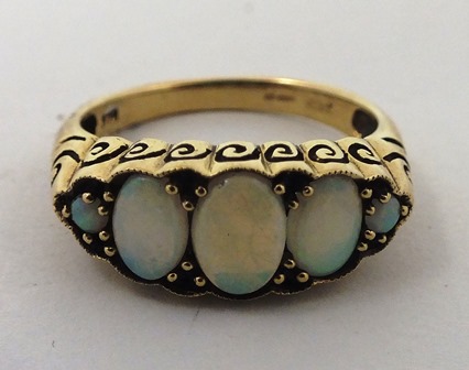 A 9ct GOLD VICTORIAN STYLE FIVE STONE OPAL HALF HOOP RING having graduated stones, bead set in a