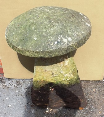 A STADDLE STONE, cap and base